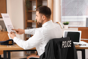 Sticker - Male police officer with document in office