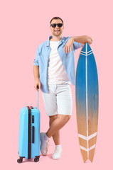 Sticker - Male tourist with suitcase and surfing board on pink background