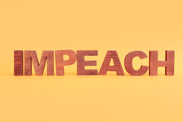 Wall Mural - Wooden letters spelling word IMPEACHMENT on orange background