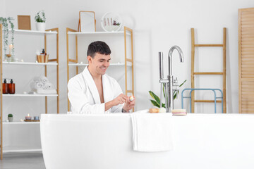 Sticker - Young man lighting candle in bathroom