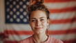 portrait of a cute girl against the background of the American flag.