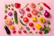 Colorful pattern made of various fresh vegetables on pink pastel background.
