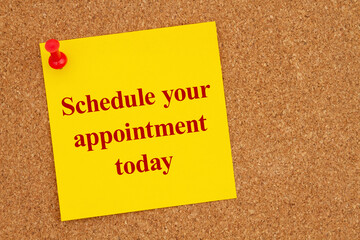 Wall Mural -  Schedule your appointment today on a yellow sticky note on corkboard