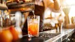 Bartender pouring orange cocktail in a highball glass, vibrant bar setting