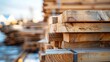 Selective focus image of stacks of lumber sitting at a construction site of a new home. Horizontal shot.