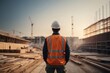 © free - back view of architect engineer or contractor at construction site supervising building