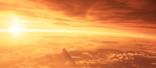 A bright orange sun is rising over a cloudy sky, global warming concept
