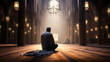 A man praying in a mosque with the light shining through the windows. Muslim Man Praying in a Mosque with Rays of Light