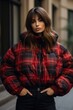 © OhmArt - A plaid puffer jacket worn over a sweater and jeans for a cozy and on-trend winter look. Woman fashion christmas.