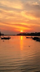 Wall Mural - sunrise at the tropical Island Koh Mook Thailand with fishing boats in the ocean