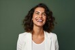 Portrait of a happy young business woman laughing isolated over green background