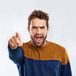 Angry man, portrait and pointing to you with shout for choice, pick or frustration on a gray studio background. Frustrated male person or model yelling or screaming with mood or attitude on mockup