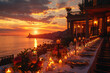 A long table set for an elegant evening party on the seafront of La Jhouette in Bellaoli, Italy with candles and flowers. The sunset casts warm hues across the sky over iconic Italian architecture.