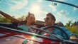 A man and a woman enjoying a drive in a red convertible car. Perfect for travel and transportation concepts