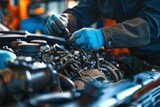 Fototapeta Tęcza - Close-up of mechanic hands repairing car engine in auto repair shop 