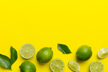 Wall Mural - Lime fruits with green leaf and cut in half slice isolated on white background. Top view. Flat lay with copy space