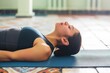 yoga practitioner in a neckstretch pose on a mat