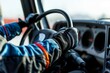 closeup of a driver gripping a racing truck steering wheel with gloves