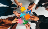 Fototapeta Do akwarium - Businessmen working together to build a puzzle as teamwork, partnership and integration concept