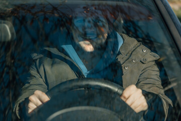 Wall Mural - young man driving behind the wheel of the car