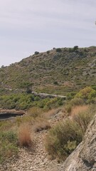 Wall Mural - A walk through the hills of Castellon. A fenced path climbs up. A sunny warm day in Spain. A popular place in the park for outdoor activities.
