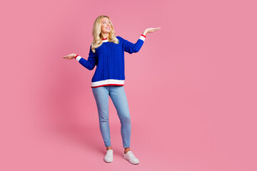 Sticker - Full length portrait of pretty lady look hold empty space wear blue sweater isolated on pink color background