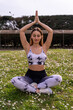 © Marino Bocelli - young charming blonde sporty woman in sportswear practicing yoga philosophy in a field of daisies