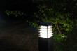 A solar powered lawn lamp illuminates the backyard at night