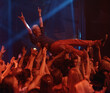 © Mariusz S/peopleimages.com - Person, excited and crowd surf at concert, live show and performance for heavy metal band at night. Happy, devil horns and audience carrying man with cheers, energy and joy with loud music in Turkey
