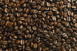 A captivating close-up image capturing the rich, dark tones and intricate textures of roasted coffee beans. Ideal for projects related to coffee, beverages, or gourmet food. Background