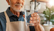 Closeup of a wrinkled hand of an elderly man holding a glass of fresh water, concept of correct hydration of the human body in adulthood. Generative Ai.