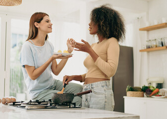 Wall Mural - Romantic lesbian couple standing in kitchen enjoy cooking lunch together at home. Afro hair multiethnic gay woman and girlfriend happy leisure activity marriage equality. LGBT LGBTQ diversity people.