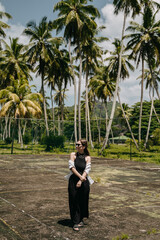 Women on a road with palm trees in black