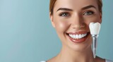 Fototapeta Sypialnia - A happy young woman with a bright white smile and a dental implant after a denture prosthesis operation. Dental surgery at a medical clinic or dentist.