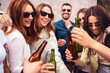 A vibrant group of friends - toasting with cold beers, sunglasses on - joyful outdoor party, moments of laughter and cheers, socializing, carefree lifestyle - Friendship bonds, and good times.