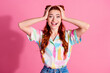 Photo of ecstatic funky girl dressed colorful blouse staring at unbelievable discount hands on head isolated on pink color background