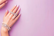 © Hunman - Hand of beautiful woman wearing stylish jewellery on lilac background with space for text.