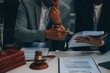 Consultation and conference of Male lawyers and professional businesswoman working and discussion having at law firm in office. Concepts of law, Judge gavel with scales of justice.