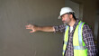Senior architect or civil engineer inspection after plaster wall at construction site. building project