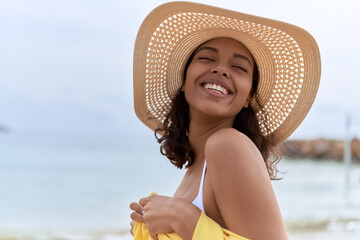 Canvas Print - Young african american woman smiling confident wearing summer hat and bikini at beach