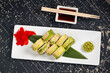 Green dragon sushi roll with eel, avocado, cucumber and ginger, accompanied with fried tempura shrimp. Traditional asian rice sushi healthy seafood