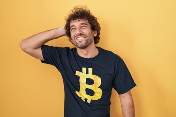 Sticker - Hispanic young man wearing bitcoin t shirt smiling confident touching hair with hand up gesture, posing attractive and fashionable