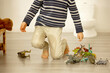 Little toddler child, boy,  pee in his pants while playing with toys, child distracted and forget to go to the toilet
