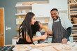 © chokniti - In a home kitchen, black father and his daughter bond over cooking a meal food, their laughter and love filling the air, embodying the joy of African American family life, Father's Day concept