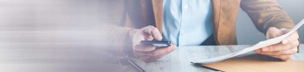 Wall Mural - man hand phone with document on desk