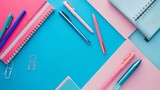 Fototapeta Zwierzęta - Organized school supplies: top view of simple & neat blue and pink items with ample copy space for creativity