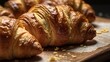 Freshly baked croissants on a wooden board, close up