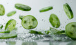 sliced cucumber floating in the air on the white background.