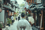 Fototapeta Uliczki - A woman wearing a white kimono walks down a narrow street in a foreign country