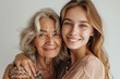 © Snapshot Lens - Portrait of old mother and mature daughter. Happy senior mom and adult daughter embracing with love on a white background, Generative AI